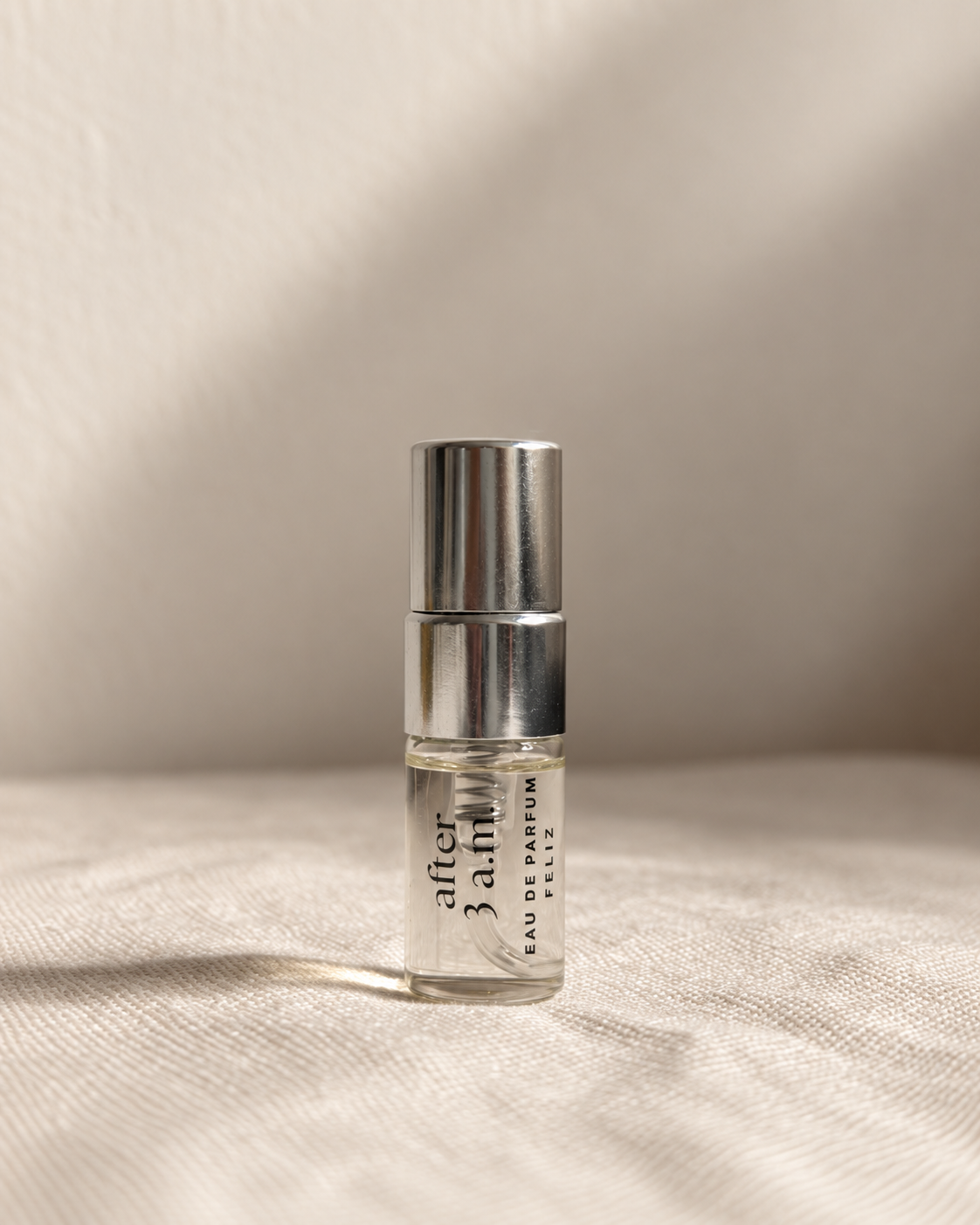 03 after 3 a.m. body perfume, 2ml sample bottle on warm linen