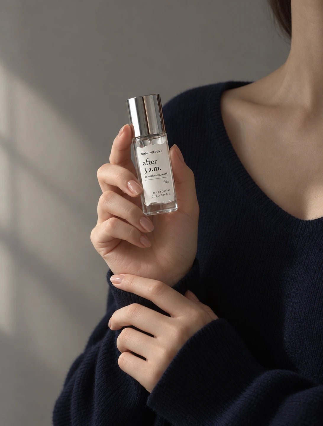 03 after 3 a.m. 10ml body perfume held in a hand