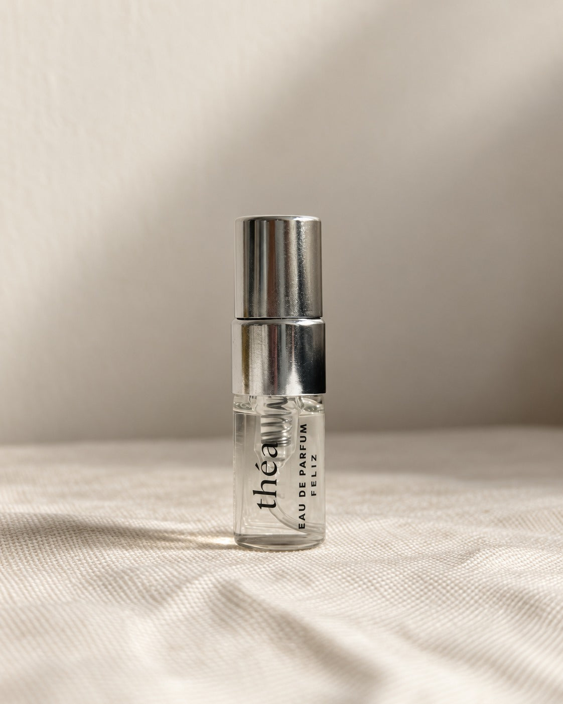 01 théa 2ml perfume sample bottle on warm linen