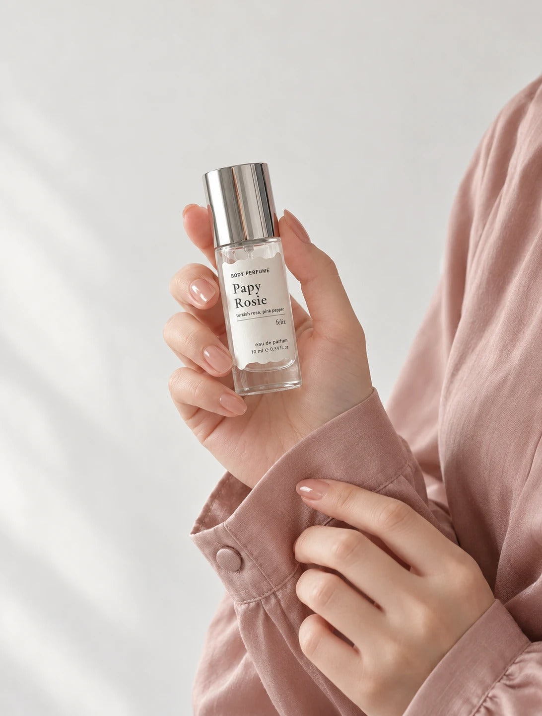 02 Papy ~ Rosie 10ml body perfume held in a hand