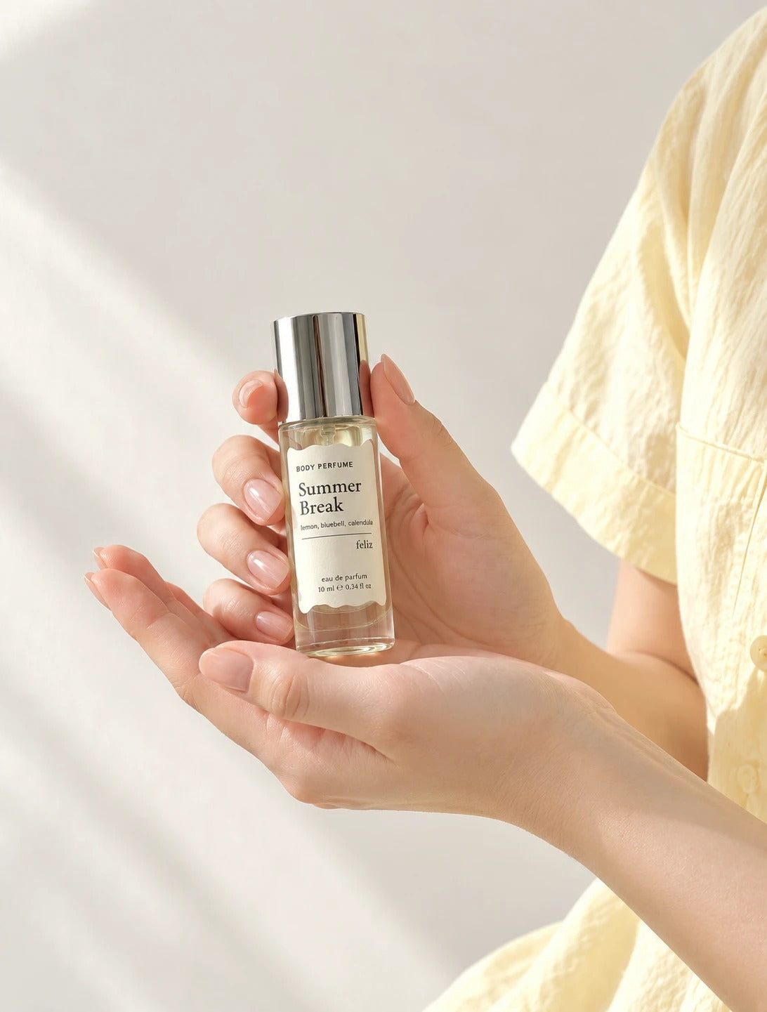 04 Summer Break 10ml body perfume held in an open hand