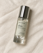 01 théa body perfume, 10ml bottle on warm linen